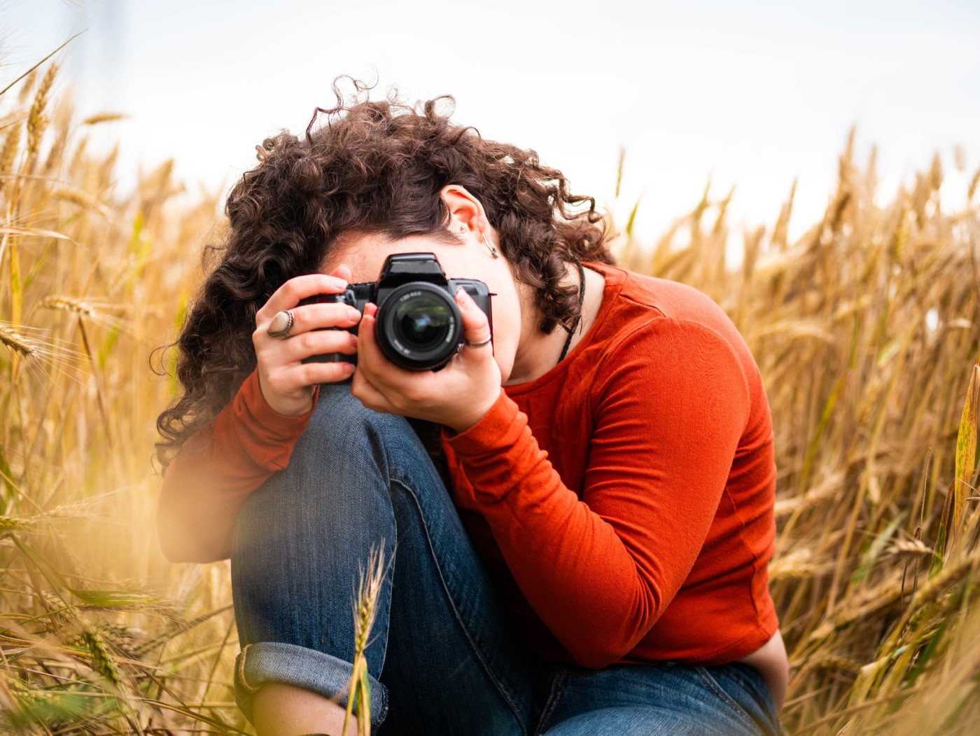 shallow focus shot of young female photographer - engaging photos for photographer website